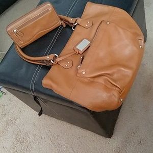 Dk tan Tignanello leather bag and wallet set.